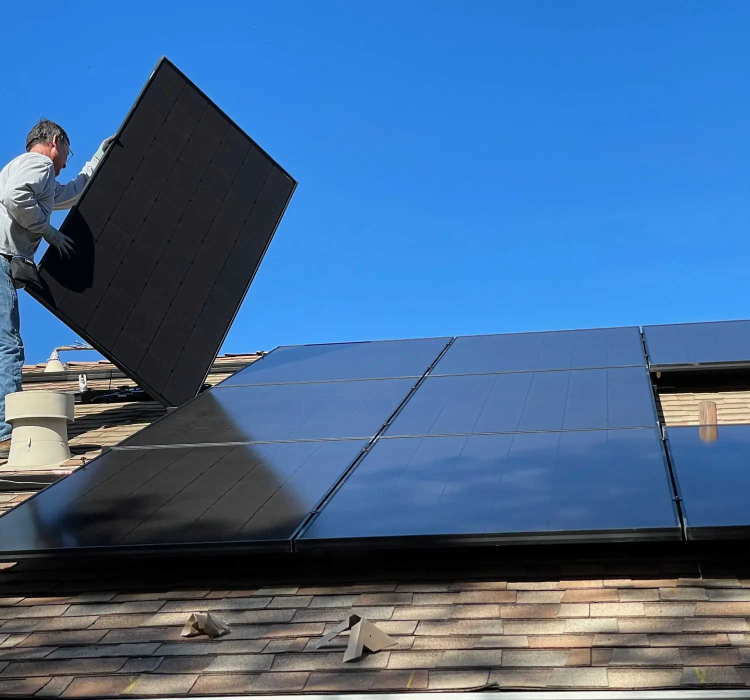Installateur legt zonnepanelen op een dak